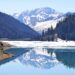 Mountain lake surrounded by mountains reflecting calm water, symbolizing healing and personal transformation