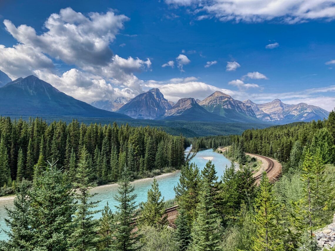 A scenic mountain landscape with a winding river, symbolizing the journey of building self-trust, personal growth, and moving forward with confidence.