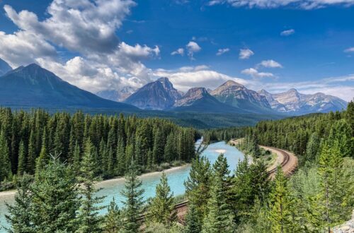 A scenic mountain landscape with a winding river, symbolizing the journey of building self-trust, personal growth, and moving forward with confidence.