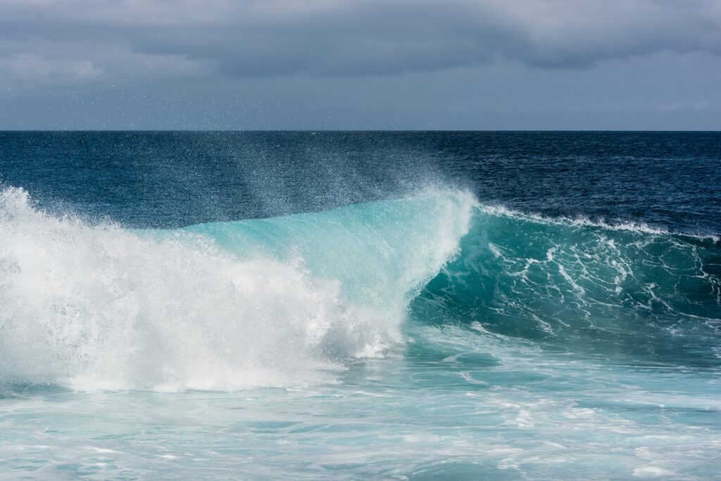 Ocean wave crashing on the shore, symbolizing emotional regulation, resilience, and learning to respond rather than react.