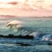 Powerful ocean wave breaking in the sea, symbolizing emotional boundaries and letting go of what isn't yours to carry