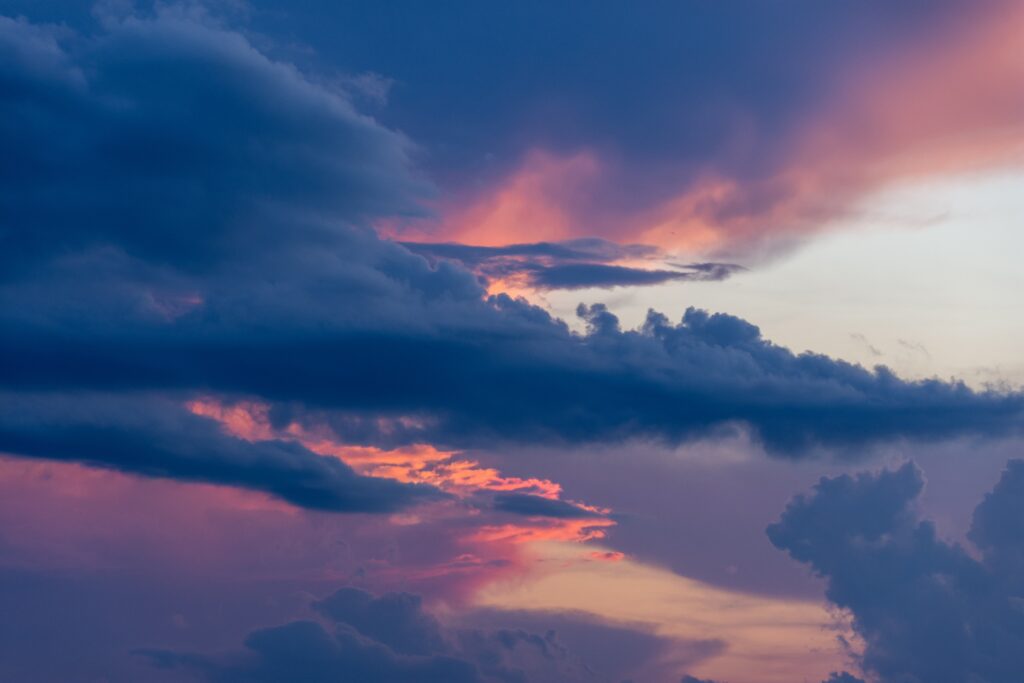 Sunlight breaking through dark clouds at sunset