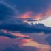 Sunlight breaking through dark clouds at sunset